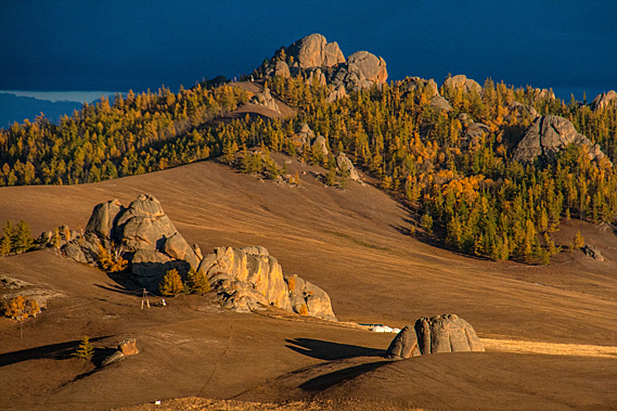Golden hills and dark stormy sky