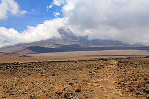 The wind tries to clear the clouds from the mountain 