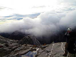 Morning cloud rapidly rising over the mountain